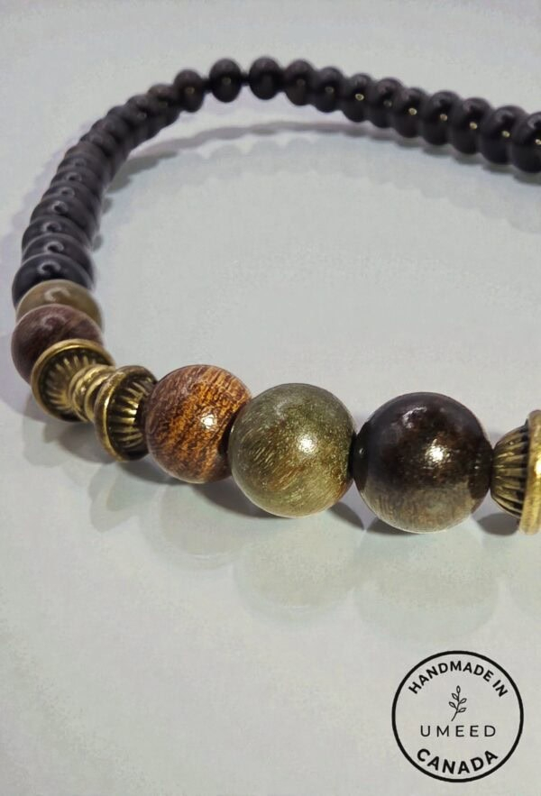 Handmade beaded necklace with black, brown, and gold beads, crafted in Canada by Umeed Designs.
