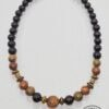 Handmade beaded necklace with black, brown, and gold beads from Umeed Designs.