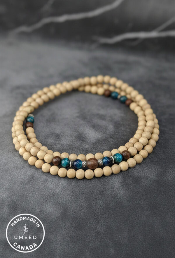 Elegant beaded necklace featuring natural wood beads and blue accents, handcrafted by Umeed Designs.