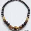 Elegant beaded necklace with wooden and gold accents, handcrafted jewelry from Umeed Designs.