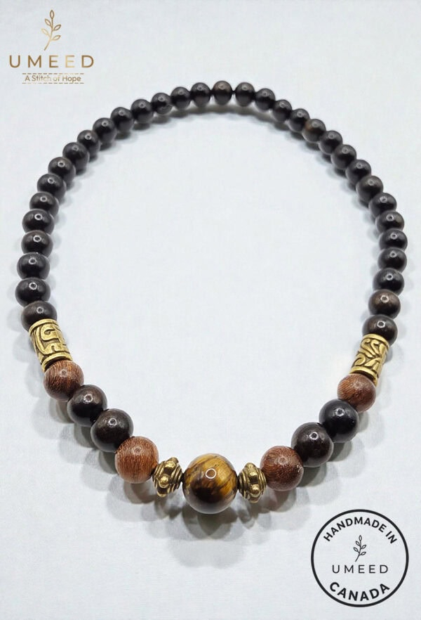 Elegant beaded necklace with wooden and gold accents, handcrafted jewelry from Umeed Designs.