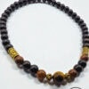 Elegant black and gold beaded necklace with wooden accents, handcrafted by Umeed Designs.