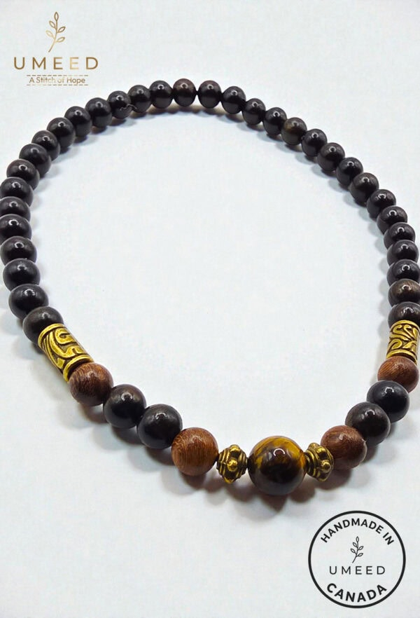 Elegant black and gold beaded necklace with wooden accents, handcrafted by Umeed Designs.