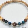 Natural wooden beaded necklace with silver accents and a central dark wood bead, handcrafted in Cana.