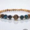Handmade beaded bracelet featuring wooden, metal, and gemstone beads from Umeed Designs.