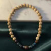 Beaded wooden necklace with natural and dark brown tones, handcrafted jewelry from Umeed Designs.