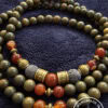 Elegant handmade beaded necklace with earthy tones and gold accents, perfect for casual or formal we.