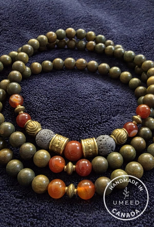 Elegant handmade beaded necklace with earthy tones and gold accents, perfect for casual or formal we.