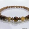 Handmade beaded necklace featuring natural wood and amber beads, crafted with care in Canada.
