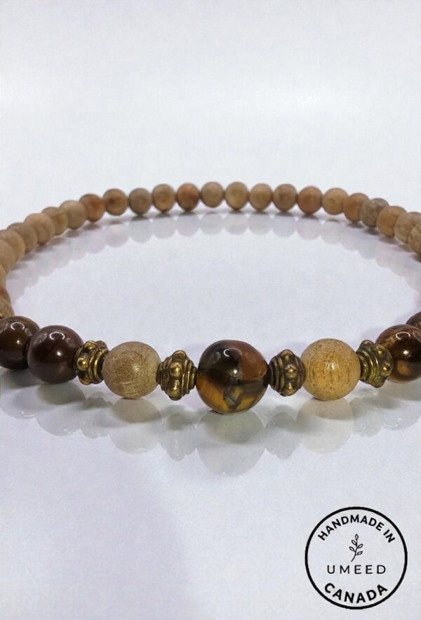 Handmade beaded necklace featuring natural wood and amber beads, crafted with care in Canada.