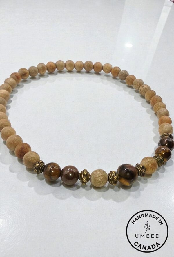 Handmade wooden beaded necklace with natural and dark brown beads, crafted in Canada.