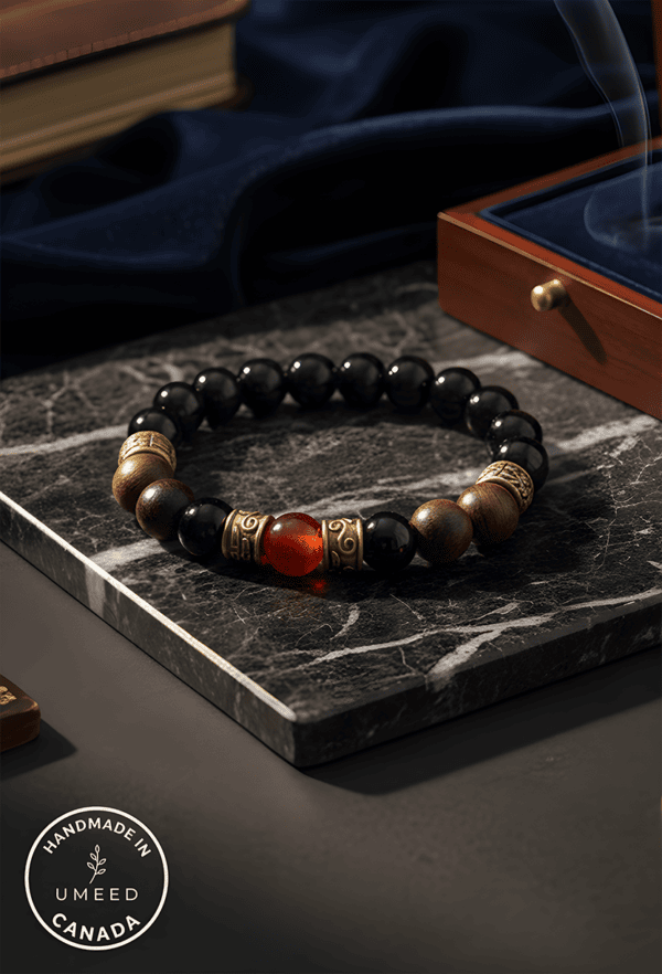 Elegant beaded bracelet featuring black, gold, and red beads, handcrafted by Umeed Designs.