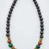 Beaded necklace featuring black, green, and wooden beads with gold accents, handcrafted in Canada.
