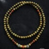 Elegant beaded necklace featuring green and orange beads with silver accents, handcrafted in Canada.