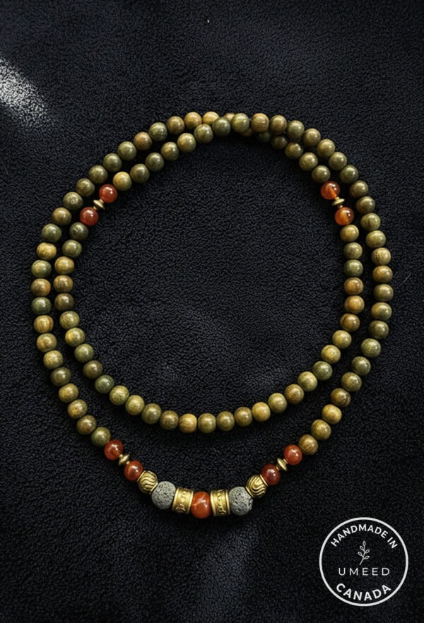 Elegant beaded necklace featuring green and orange beads with silver accents, handcrafted in Canada.