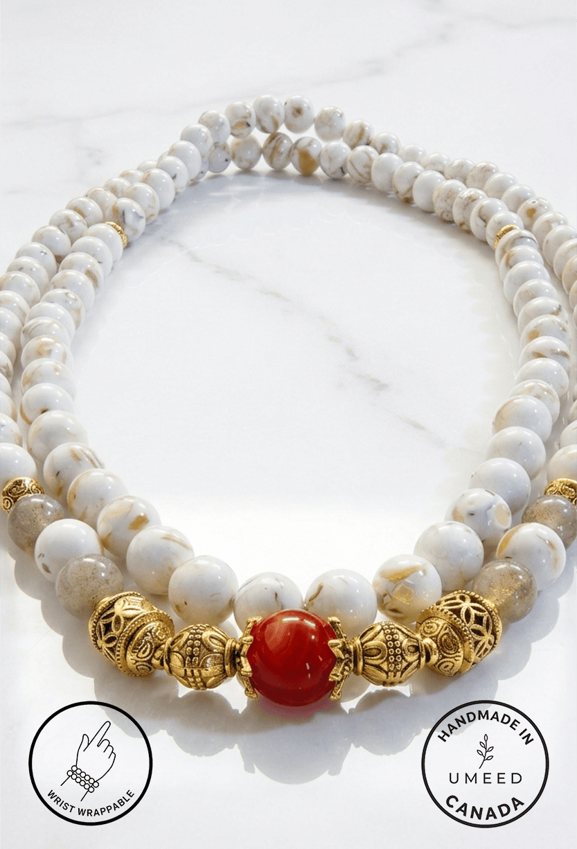 Elegant pearl and gold beaded necklace with a striking red centerpiece. Perfect for sophisticated je.