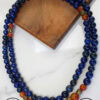 Blue beaded necklace featuring gold and red accent beads, handcrafted jewelry from Umeed Designs.