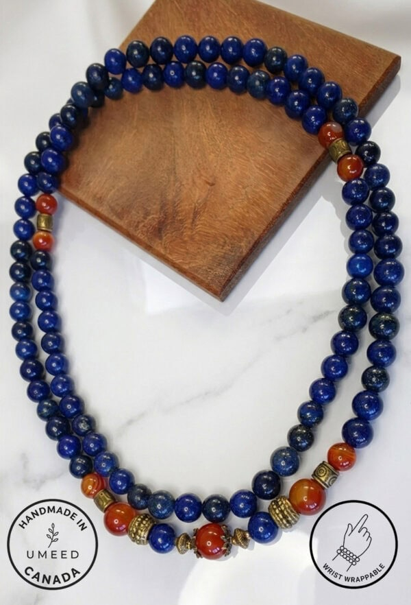 Blue beaded necklace featuring gold and red accent beads, handcrafted jewelry from Umeed Designs.
