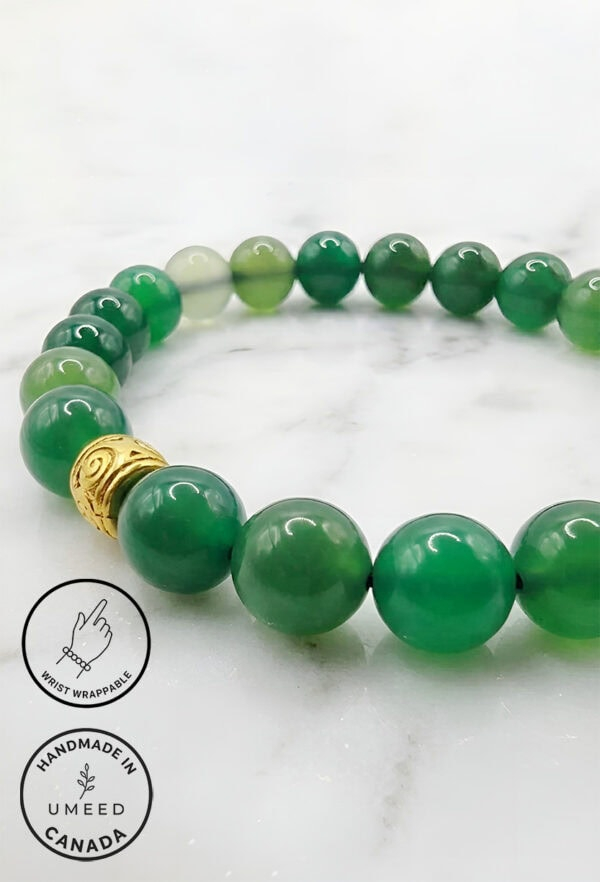 Elegant green beaded bracelet with a gold charm, handmade in Canada by Umeed Designs.