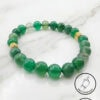 Bracelet featuring polished green beads with gold accents, handcrafted by Umeed Designs.