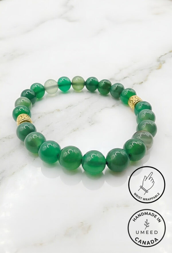 Bracelet featuring polished green beads with gold accents, handcrafted by Umeed Designs.