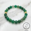 Elegant green beaded bracelet with gold accents, handcrafted by Umeed Designs in Canada.