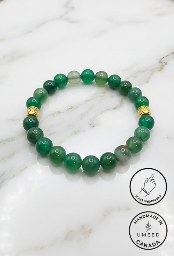 Elegant green beaded bracelet with gold accents, handcrafted by Umeed Designs in Canada.