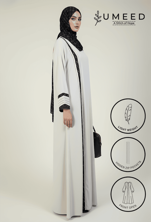 Elegant white abaya with black accents, lightweight and stylish for women.