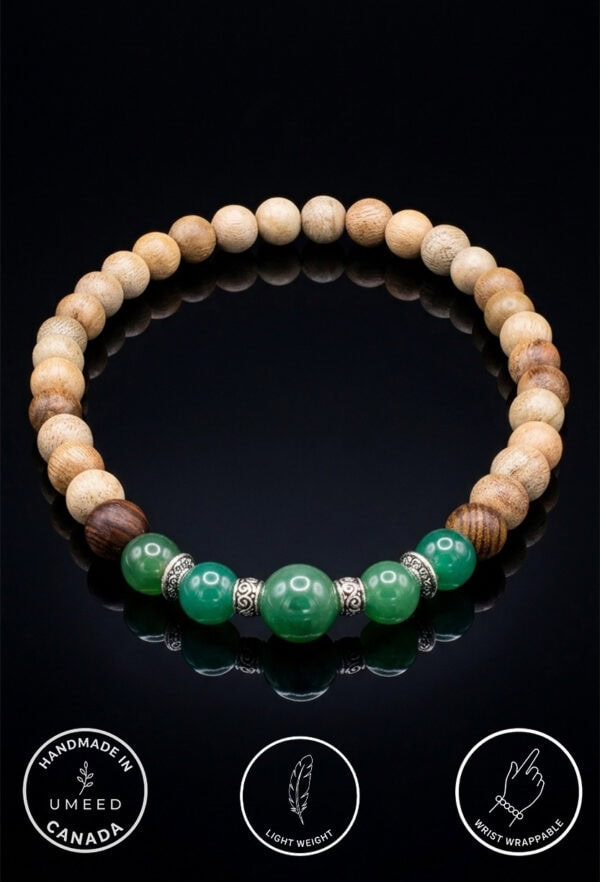 Handmade green beaded bracelet with silver accents on black background.