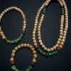 Elegant handmade beaded jewelry set with natural wood and green beads.
