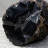 Black onyx geode crystal for jewelry making and healing practices. Unique natural stone with strikin.