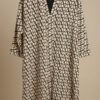 Elegant geometric patterned dress with a V-neck, beige and black design. Perfect for stylish, modern.