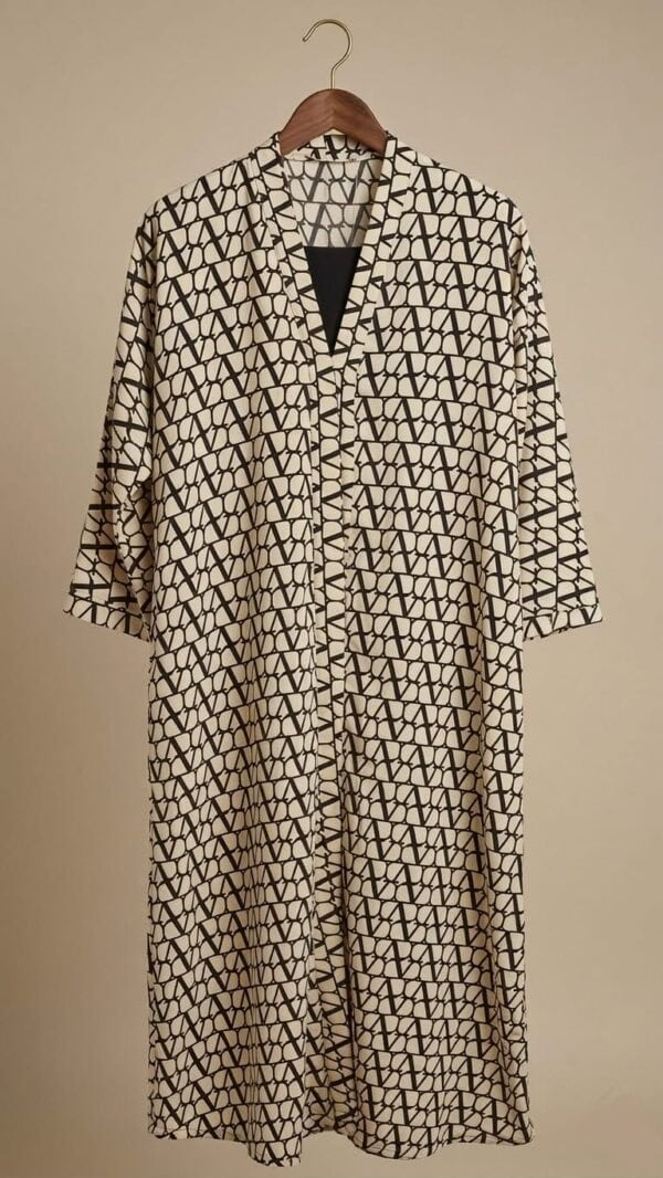 Elegant geometric patterned dress with a V-neck, beige and black design. Perfect for stylish, modern.