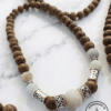 Elegant handmade wooden and beaded necklace with silver accents, crafted in Canada.