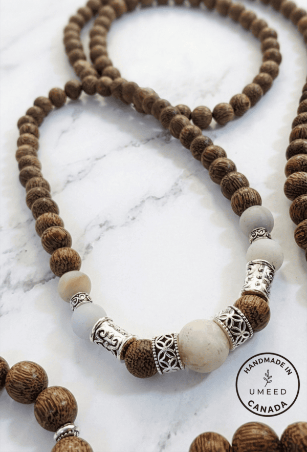 Elegant handmade wooden and beaded necklace with silver accents, crafted in Canada.