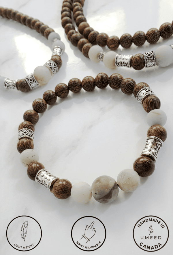 Beautiful handmade beaded jewelry featuring wooden and white beads with silver accents.