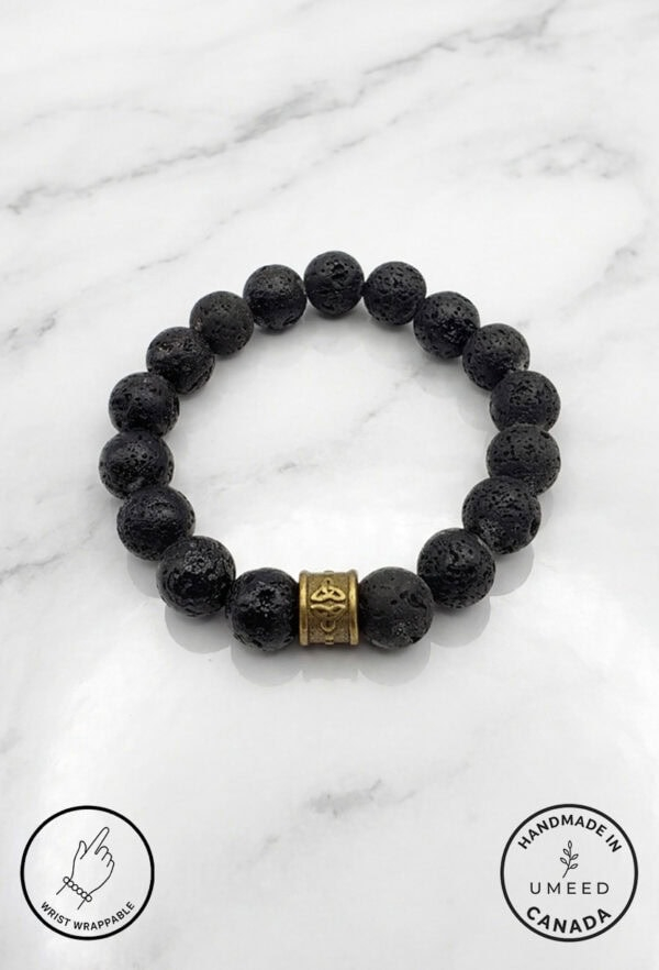 Black lava stone bracelet with a gold decorative bead, handcrafted jewelry from Umeed Designs.