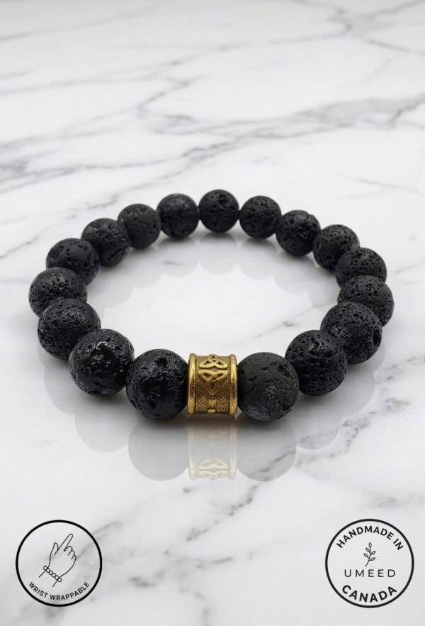 Black lava stone bracelet with gold accent bead, handmade jewelry.