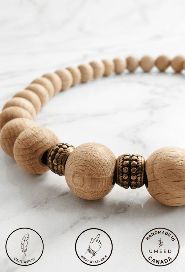 Elegant handmade wooden beaded necklace with natural wood and metallic accents.