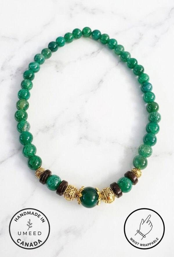 Green beaded necklace with gold and black accents, handmade jewelry from Umeed Designs.