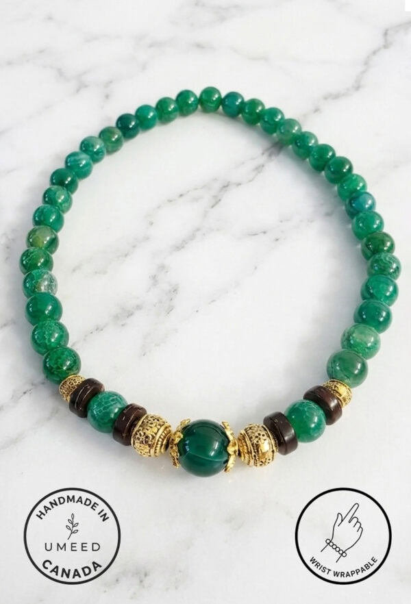 Handmade green beaded necklace with gold and black accents, crafted in Canada.