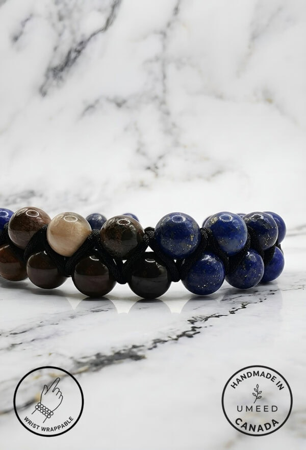Handmade beaded bracelet featuring blue and brown stones on a marble background.