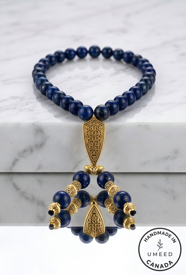 Elegant blue beaded necklace with gold accents and intricate pendant design.