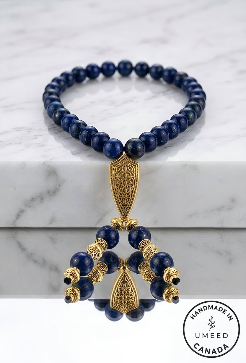Elegant blue beaded necklace with gold accents and intricate pendant design.