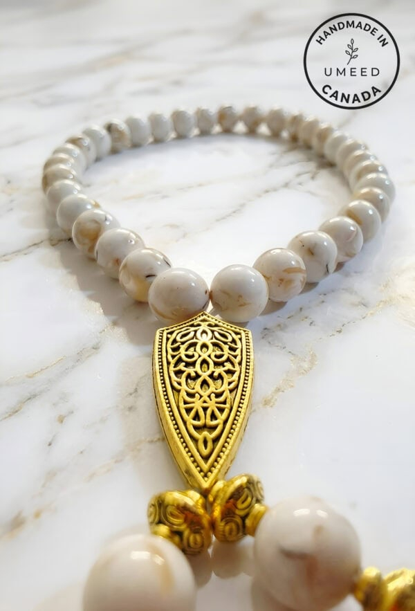 Elegant pearl and gold pendant necklace handcrafted in Canada by Umeed Designs.