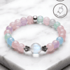 Elegant pastel beaded bracelet with silver accents, handmade in Canada, featuring a central glass be.