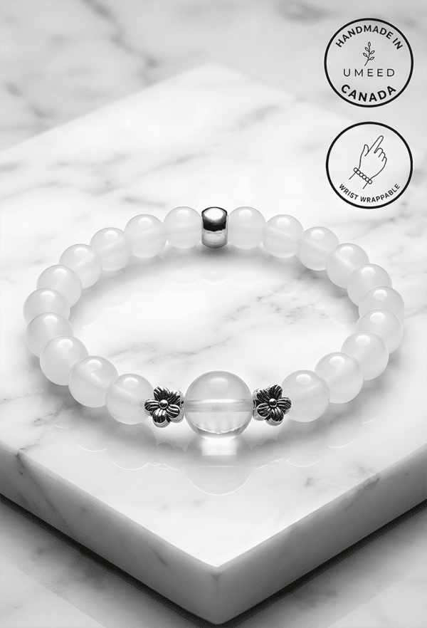 Elegant white beaded bracelet with floral accents, handmade in Canada.