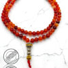 Handmade red and orange beaded mala necklace with silver and gold accents.