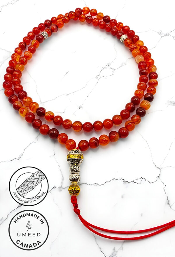 Handmade red and orange beaded mala necklace with silver and gold accents.