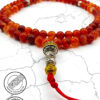 Handmade red and gold beaded mala necklace with decorative silver accents.